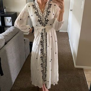 White dress with black details.